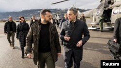 FILE - Ukrainian President Volodymyr Zelenskyy is welcomed by Switzerland's Foreign Minister Ignazio Cassis, Jan. 15, 2024, at Airport Bern Belp, Switzerland.