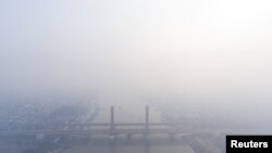 A view shows the Ampera bridge covered with smog due to wildfires in Palembang, South Sumatra province, Indonesia, Oct. 1, 2023, in this photo taken by Antara Foto. (Antara Foto/Nova Wahyudi/via Reuters) 