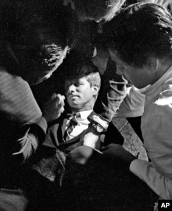 FILE - In this June 5, 1968 file photo, Senator Robert F. Kennedy, lies on the floor of the Ambassador hotel in Los Angeles moments after he was shot.