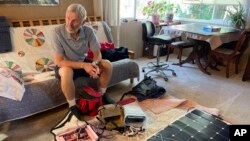 Balloon pilot Peter Cuneo looks over his gear during an interview Sept. 21, 2023, in Albuquerque, N.M. 