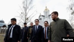 Japanese Prime Minister Fumio Kishida visits a church at site of a mass grave, in the town of Bucha, amid Russia's attack on Ukraine, outside of Kyiv, Ukraine March 21, 2023.