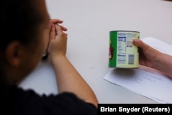 Jelainie learns to read food labels at the Holyoke Health Center in Holyoke, Massachusetts, June 11, 2024. (REUTERS/Brian Snyder)