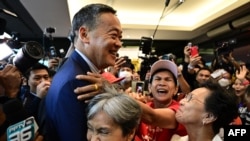 FILE - Pheu Thai Party's Srettha Thavisin, center, is hugged by supporters at the party headquarters after the parliament's prime ministerial vote in Bangkok, Aug. 22, 2023.