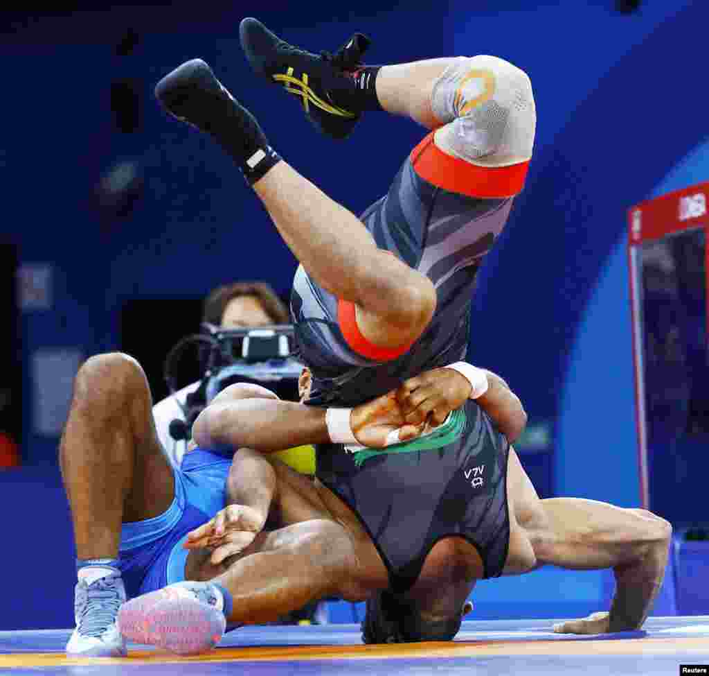Zhan Beleniuk of Ukraine and Alireza Mohmadipiani of Iran compete during their men's Greco-Roman 87kg semi-final wrestling match at the Paris 2024 Olympics at Champ-de-Mars Arena in Paris, France.