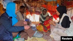 FILE - Cindy McCain, left, executive director of the U.N. World Food Program, meets an internally displaced Somali family at the Ladan camp for IDPs in Dollow, Somalia, May 1, 2023.