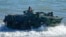 FILE - Filipino Marines maneuver their vehicle during an annual U.S.-Philippines joint military exercise on the beaches of Claveria, Cagayan province, Philippines, March 31, 2022. Maneuvers are planned off the west coast of the island of Palawan in April.