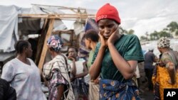 People gather at the side of an explosion in a refugee camp on the outskirts of Goma, Democratic Republic of the Congo, May, 3, 2024. 