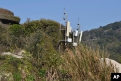 Telecom equipment is seen on top of a hill in Beigan, part of Matsu Islands, Taiwan on Sunday, March 5, 2023. (AP Photo/Huizhong Wu)