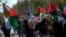 FILE - A woman waves flags in support of Palestinians in Gaza during a protest in Istanbul, April 5, 2024. Turkey and Israel announced tit-for-tat trade barriers, April 9.