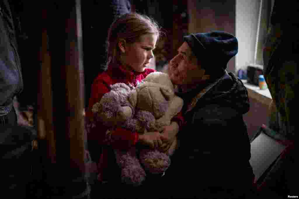 A grandfather says goodbye to his granddaughter Arina, 6, before her evacuation from front line city of Bakhmut, amid Russia's attack on Ukraine, in Donetsk region, Ukraine, Jan. 31, 2023.&nbsp;Arina is one of an estimated 11 million people displaced by the war in Ukraine, according to U.N. figures, that began when Russia invaded in February 2022.&nbsp;The grandparents initially said they did not want the little girl to leave - but eventually concluded it would be for the best.&nbsp;