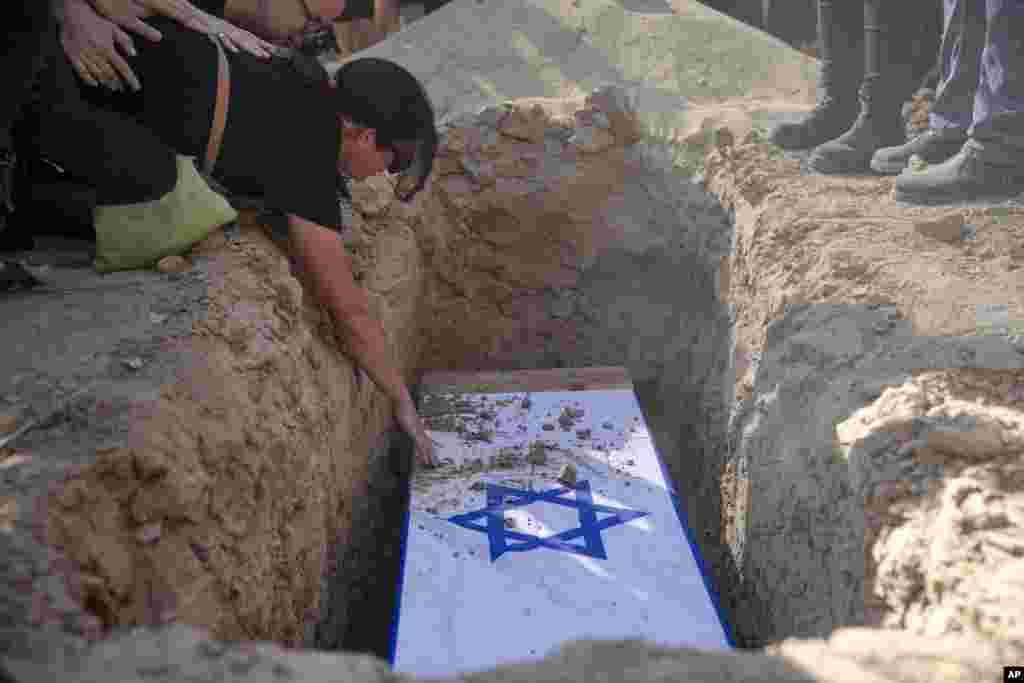 Rimon Buchshtab mourns during the funeral of her husband Yagev Buchshtab at a cemetery of the Kibbutz Nirim, southern Israel.&nbsp;&nbsp;Buchshtab's body was one of six bodies of hostages, taken in Hamas' Oct. 7 attack, recovered by Israel's military during an operation in the Gaza Strip.