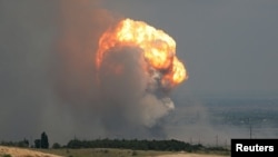 Smoke and flames rise from an explosion during a fire at a military training ground in the Kirovske district, Crimea, July 19, 2023. REUTERS/Stringer TPX IMAGES OF THE DAY