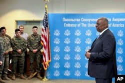 U.S. Secretary of Defense Lloyd Austin, right, speaks to employees of the U.S. embassy in Kyiv, Nov. 20, 2023.