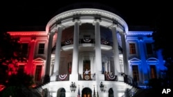 FILE - U.S. President Joe Biden waves to a crowd after a fireworks show during a Fourth of July celebration at the White House in Washington, July 4, 2022. Biden will celebrate the country’s Independence Day holiday again with a series of events at the White House on Tuesday.
