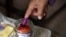 A person dips their finger in ink at a Phnom Penh, Cambodia, polling station during Cambodia's general election, July 23, 2023. A recent report by Freedom House highlighted Cambodia as one of the places that experienced attempts to control, hinder or interfere with elections. 
