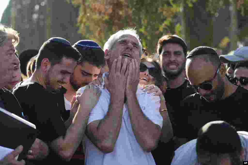 Yigal Sarusi, center, mourns during the funeral of his son, slain hostage Almog Sarusi, who was killed in Hamas captivity in the Gaza Strip, at a cemetery in Ra'anana, Israel.