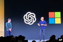 FILE - Sam Altman, left, appears onstage with Microsoft CEO Satya Nadella at OpenAI's first developer conference, on Nov. 6, 2023, in San Francisco. (AP Photo/Barbara Ortutay, File)