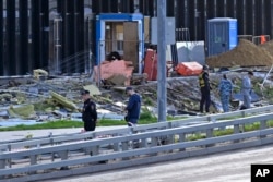 Investigators examine a damaged building after a reported drone attack in Moscow, Russia, July 24, 2023.