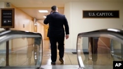 FILE - A man speaks on his phone at the Capitol in Washington, June 22, 2022. Lobbying firms in Washington reportedly are dropping clients from China amid growing concerns about Beijing’s influence on Capitol Hill.