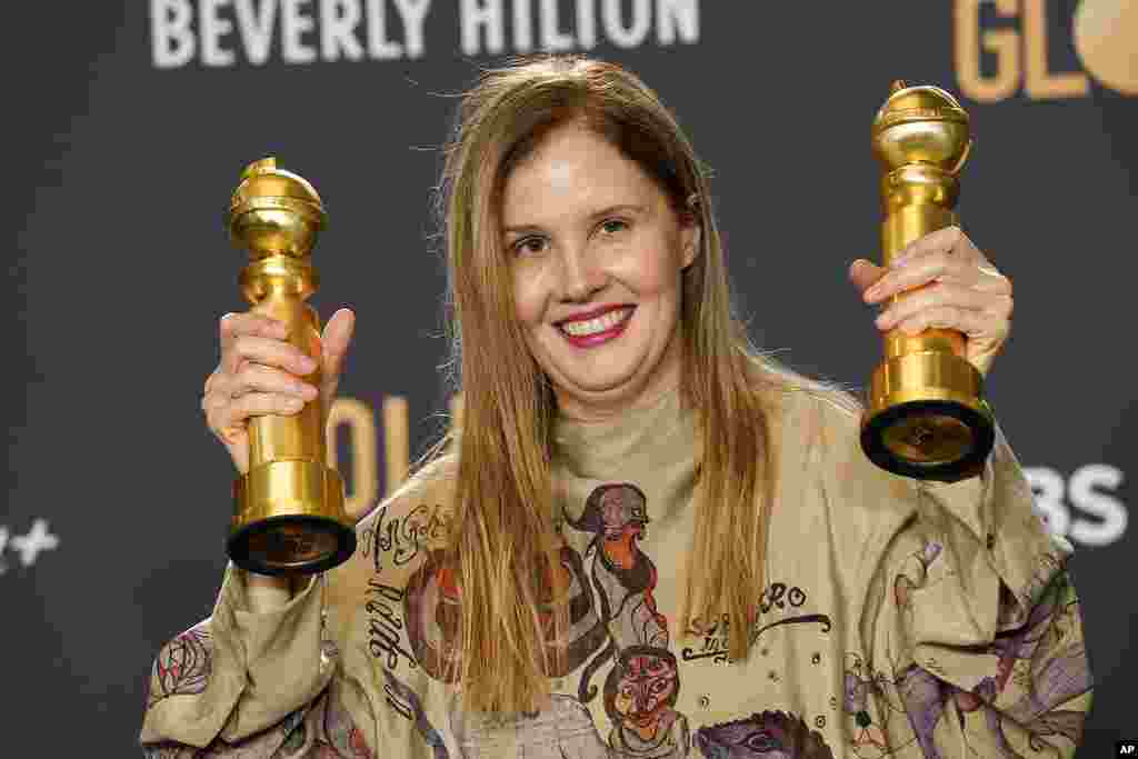 Justine Triet poses with the awards for best screenplay, motion picture for "Anatomy of a Fall" and for best motion picture, foreign language for "Anatomy of a Fall" in the press room at the 81st Golden Globe Awards on Jan. 7, 2024.