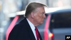 Former President Donald Trump leaves his apartment building in New York, Jan. 17, 2024, planning to attend the penalty phase of a civil defamation trial over a columnist's claims he sexually attacked her in a department store dressing room in the 1990s.