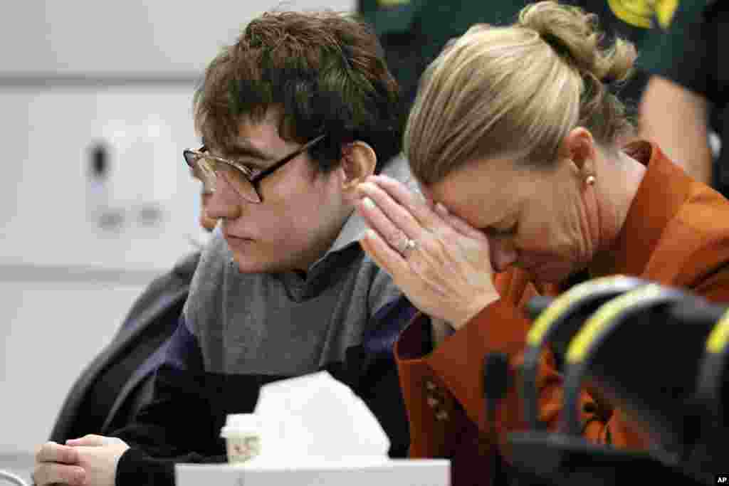 Assistant public defender Melisa McNeill, seated with Marjory Stoneman Douglas High School shooter Nikolas Cruz touches her hands to her head as the last of the 17 verdicts were read in the penalty phase of Cruz's trial at the Broward County Courthouse in Fort Lauderdale.