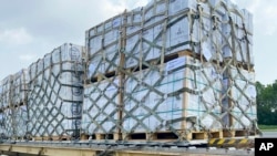 In this handout photo released by Pakistan Foreign Ministry Press Service, Local workers unload relief, sent by US government to Pakistani people from a U.S Air force plane at Noor Khan Air Base, in Islamabad, Sept. 9, 2022. (Pakistan Foreign Ministry Pr
