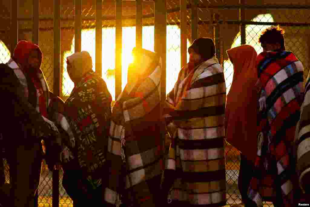 Venezuelan migrants, some expelled from the U.S. to Mexico under Title 42 and others who have not yet crossed after the new immigration policies, queue outside of the National Migration Institute (INM) to process a permit to stay in Mexico for 180 days, in Ciudad Juarez, Oct. 24, 2022.