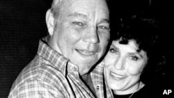 FILE - Country music singer Loretta Lynn embraces her husband, Oliver 'Mooney' Lynn, during rehearsal for her New York debut, on Oct. 21, 1982.