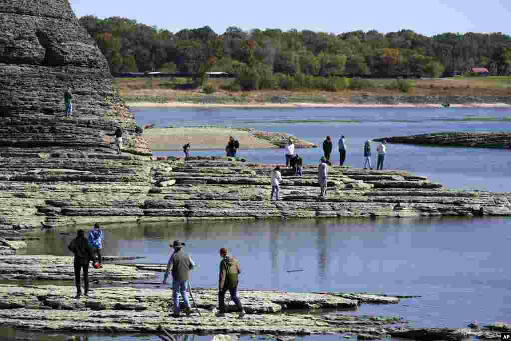 People walk to Tower Rock, an attraction normally surrounded by the Mississippi River and only accessible by boat, Oct. 19, 2022, in Perry County, Missouri.
