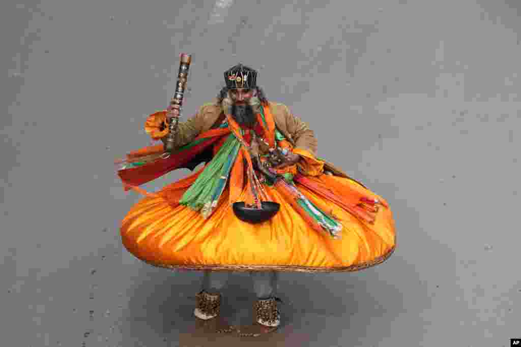 A Muslim dervish whirls during celebrations for Mawlid al-Nabi that marks the birthday of the Muslim Prophet Muhammad, in Peshawar, Pakistan.