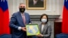 Taiwan's President Tsai Ing-wen, at right, exchanges gifts with U.S. Indiana Governor Eric Holcomb during a meeting at the Presidential office in Taipei, Taiwan, Aug 22, 2022, in this photo released by the Taiwan Presidential Office.