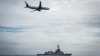 FILE - A Royal Australian Air Force P-8A Poseidon aircraft making a low pass over Royal Australian Navy destroyer HMAS Hobart during Fleet Certification Period, Feb. 24, 2022