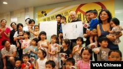 小朋友手持印有「停」字的波板(球拍)糖，呼籲當局停止洗腦式國民教育