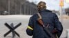 A member of the Territorial Defence Forces of Ukraine stands guard at a checkpoint on the outskirts of Kyiv, Ukraine, Feb. 27, 2022. 