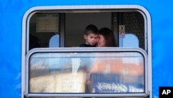 Refugees fleeing the conflict from neighboring Ukraine wait for their departure to the Czech Republic at the Przemysl train station in Przemysl, Poland, Feb. 26, 2022.