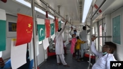 FILE - Passengers ride in an Orange Line Metro Train, a metro project planned under the China-Pakistan Economic Corridor, Oct. 26, 2020. Russia, Venezuela and Pakistan are the top three recipients of Chinese development funding in the past two decades.
