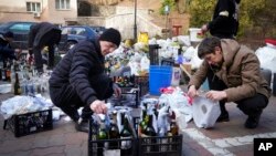 Members of civil defense prepare Molotov cocktails in a yard in Kyiv, Ukraine, Feb. 27, 2022.