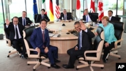 Japanese Prime Minsiter Shinzo Abe, foreground center left, and U.S. President Barack Obama, foreground center right, smile at photographers with other leaders of Group of Seven industrial nations. (Pool via AP)