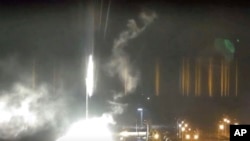 This image made from a video released by Zaporizhzhia nuclear power plant shows bright flaring object landing in grounds of the nuclear plant in Enerhodar, Ukraine Friday, March 4, 2022. (AP)