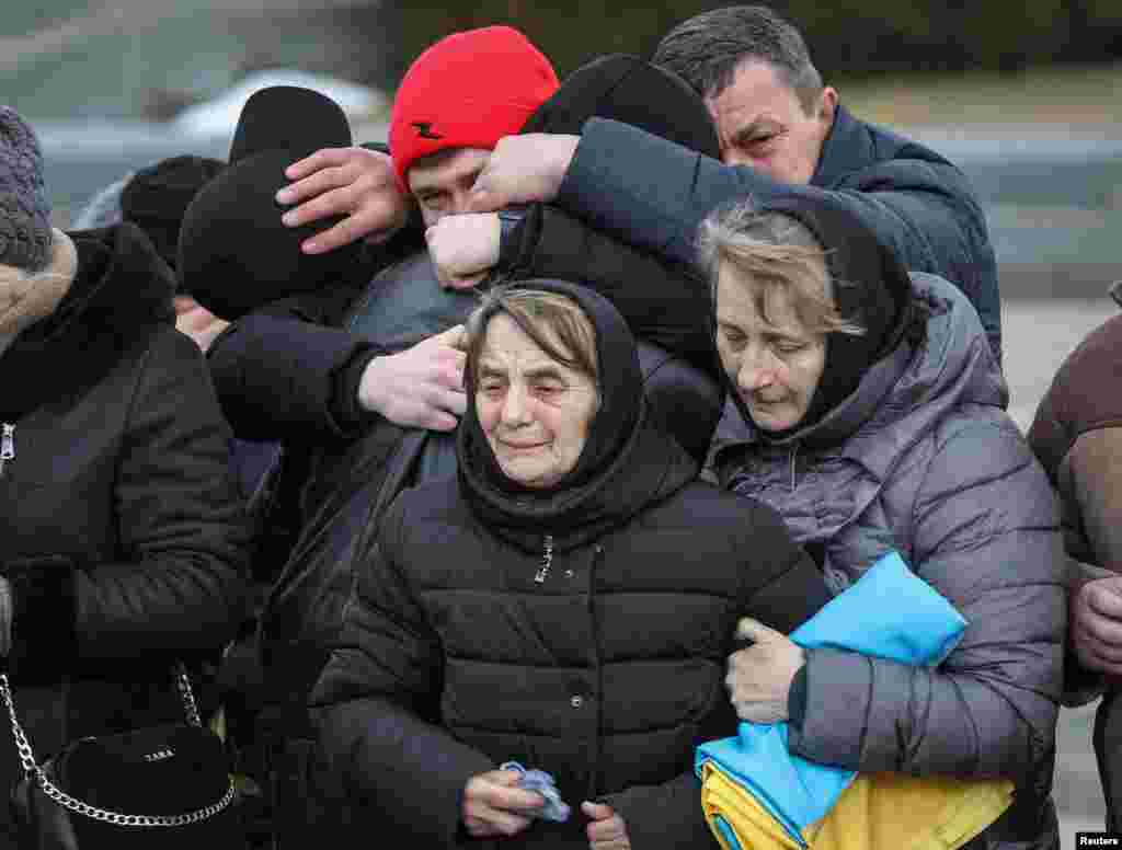 Myroslava Dudar attends the funeral of her son Viktor Dudar and Ivan Koverznev, of Ukrainian servicemen killed on March 2, during Russia's invasion of Ukraine, at an 18th-century Lychakiv cemetery, in Lviv, March 8, 2022.