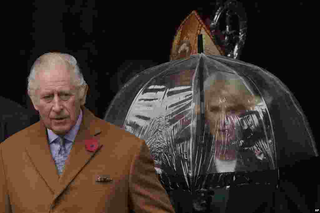 Britain's King Charles III and Camilla, the Queen Consort, walk out of York Minster as they go to unveil a statue of the late Queen Elizabeth II in York, England.