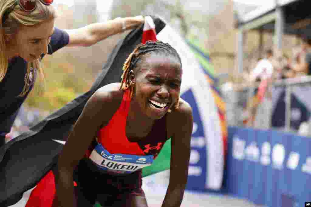 Sharon Lokedi of Kenya reacts after crossing the finish line first in the women's division of the New York City Marathon.