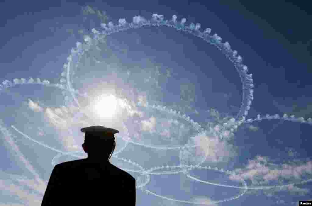 Japan Air Self-Defense Force's (JASDF) aerobatic flight team "Blue Impulse" performs during an International Fleet Review to commemorate the 70th anniversary of the foundation of Japan's Maritime Self-Defense Force (JMSDF), at Sagami Bay, off Yokosuka, south of Tokyo.