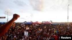 FILE - Demonstrators shout anti-government slogans during a rally to protest the country's economic crisis, in Colombo, Sri Lanka, April 23, 2022.
