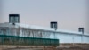 FILE - A person stands in a tower on the perimeter of the No. 3 Detention Center in Dabancheng in western China's Xinjiang Uyghur Autonomous Region on April 23, 2021. Human rights groups and Western nations have accused China of massive crimes against the