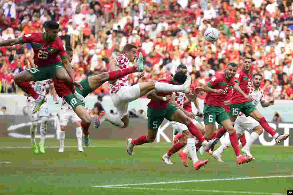 Croatia's Mario Pasalic, center, reaches for the ball during the World Cup group F soccer match between Morocco and Croatia, at the Al Bayt Stadium in Al Khor, Qatar.