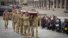 Ukrainian servicemen carry the coffin of their comrade Oleh Yurchenko, killed in a battle with Russian forces in the Donetsk, region during a memorial ceremony in Independence Square in Kyiv, Jan. 8, 2023. 