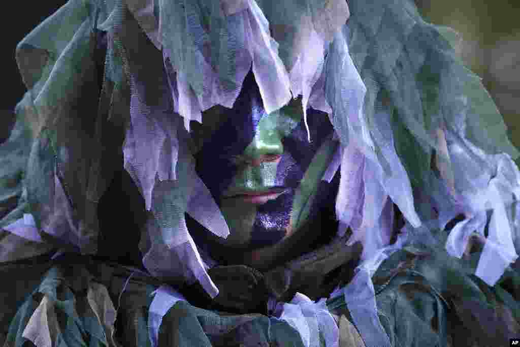 An Indian army sniper takes position during a military drill at the Indo-U.S. joint exercise, or Yudh Abhyas, in Auli, in the Indian state of Uttarakhand.