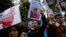 Protesters chant slogans as they hold posters and pictures of victims during a protest against China's brutal crackdown on Uyghurs, in front of the Chinese consulate in Istanbul, Turkey, Nov. 30, 2022. 